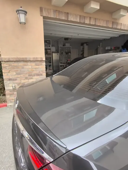 Rear deck of a dark Mercedes-Benz sedan before scratch removal