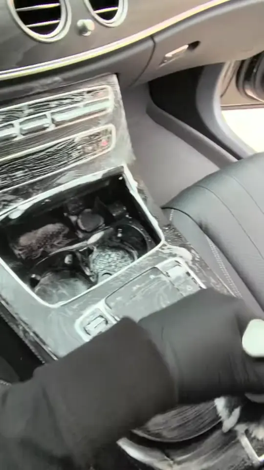 Detailing the center console and cup holders of a Mercedes-Benz