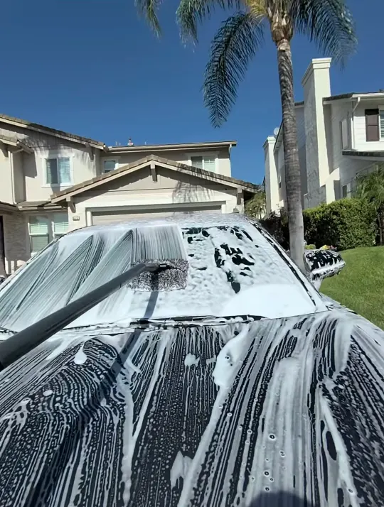Foam sheeting off the roof and glass of a Lexus