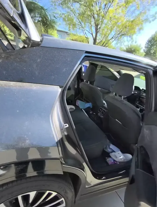 Gray Lexus SUV with rear door open before its interior cleaning