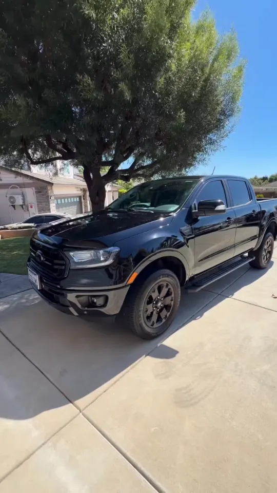 Black Ford Ranger in a driveway after its paint enhancement and protection