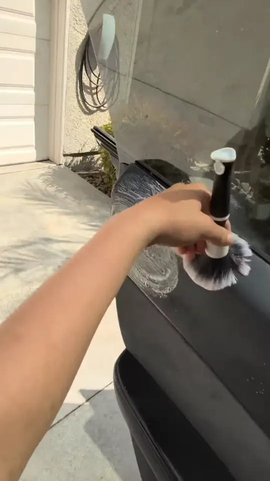 Brushing dust out of a Tesla door panel