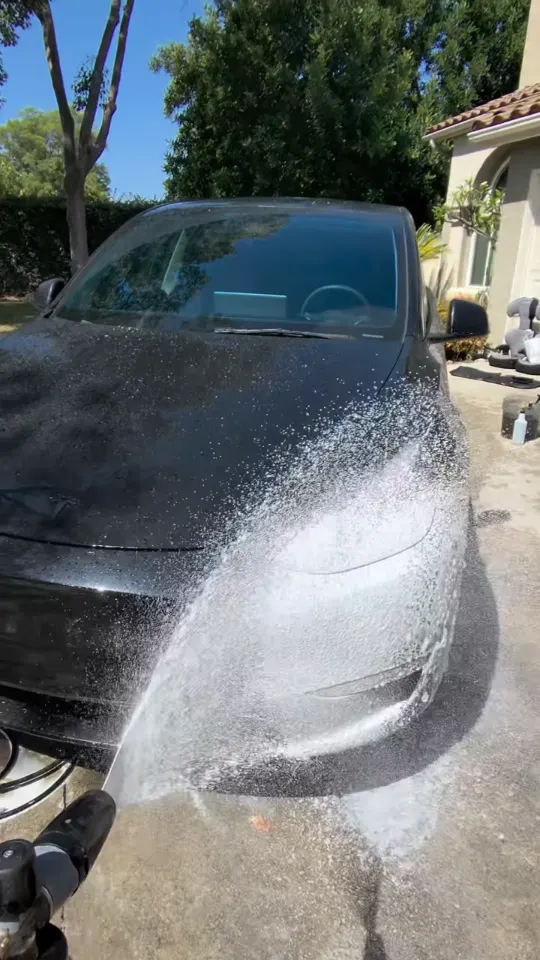 Rinsing the front of a black Tesla Model Y