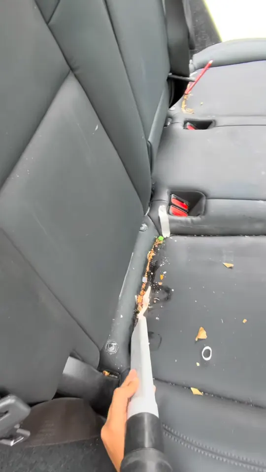 Vacuuming the seat track and rear footwell of a Tesla